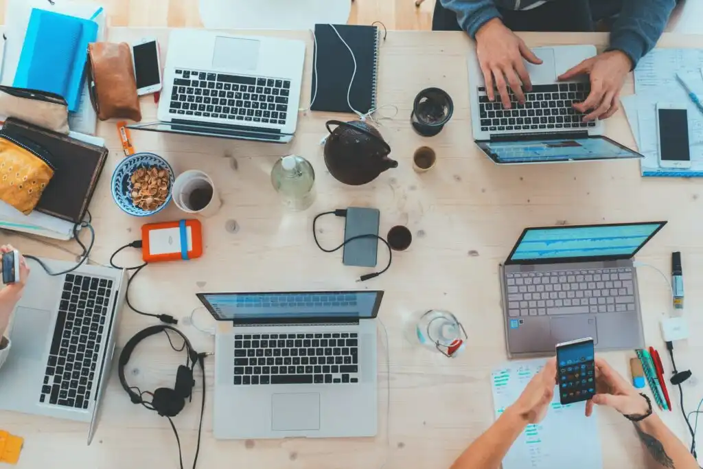 About Us Image of a work table with individuals around it